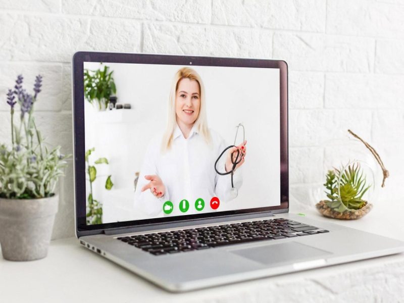 Laptop screen showing a female doctor in a white coat during a video call, used for online medical learning