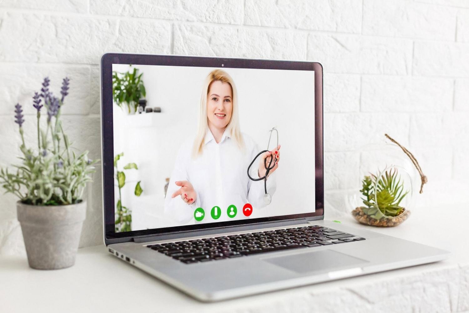 Laptop screen showing a female doctor in a white coat during a video call, used for online medical learning